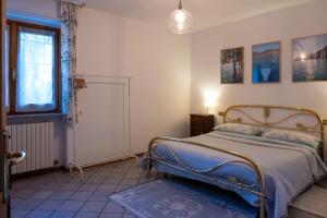 a bedroom with a bed and a window at Casa Emilia in Riva di Solto
