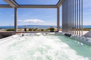 a jacuzzi tub with a view of the ocean at Apartments Blue Maris Žnjan in Split