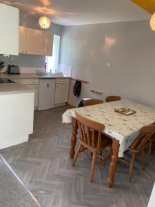 a kitchen with a table and chairs in a room at Barfad Self Catering Holiday Cottages in Tarbert