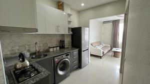 a kitchen with a refrigerator and a washing machine at ANDREA Villa in Batumi