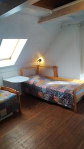 a bedroom with two beds and a table and a window at Jesenická přehrada, u vody in Cheb
