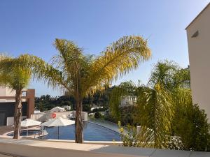 a view of a swimming pool with palm trees at Luxurious in nature in Málaga