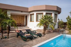 a villa with a swimming pool and a house at Maia Luxury Pool Villa in Afantou