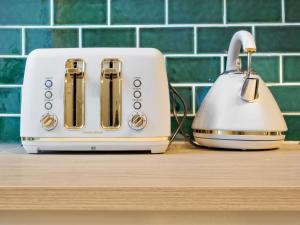 a white toaster sitting on a kitchen counter at VENUS Central Sydney - FEMALE ONLY HOSTEL in Sydney
