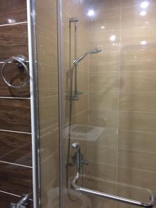 a shower with a glass door in a bathroom at Amr Diab Florenza studio in Hurghada