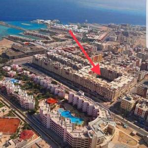 an aerial view of a city with a red arrow at Amr Diab Florenza studio in Hurghada