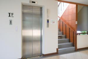 an elevator in a building with a staircase at Rattana Park Hotel in Phitsanulok