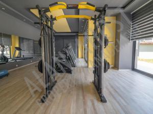 un gimnasio con dos máquinas de correr en una habitación en Calypso Residence Luxurious Beachside Apartment in Alanya D6, en Alanya