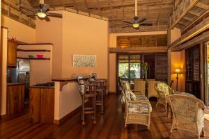 a living room with a bar and chairs at Tropical Breeze in Palmetto Bay in Palmetto Bay