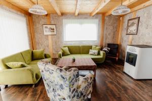 a living room with a couch and chairs and a table at VillaLaylaRostovo in Bugojno