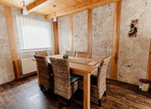a dining room with a wooden table and chairs at VillaLaylaRostovo in Bugojno +17 photos