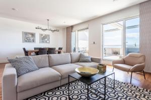 a living room with a couch and a table at Apartments Blue Maris Žnjan in Split