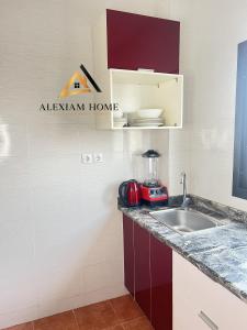 a kitchen with a sink and a counter top at Studio Moderne et Chic in Douala