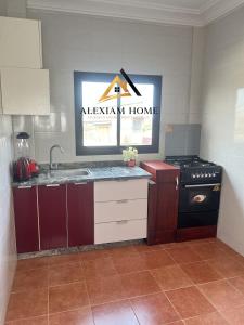 a kitchen with a sink and a stove in it at Studio Moderne et Chic in Douala +10 photos