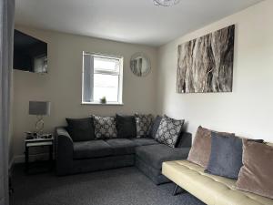 a living room with a couch and a window at Safari Avenue one Bedroom Apartment in Stapleford