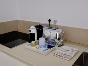 a kitchen counter with a coffee maker on it at MILORA SuNSET in Pollonia