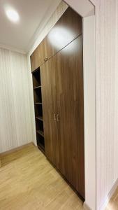 a closet with a wooden door in a room at Marrone Hotel Tsaghkadzor in Tsaghkadzor