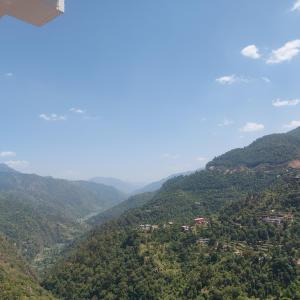a view of a valley with trees and mountains at Mount heaven in Kandāghāt