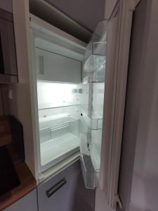 an empty refrigerator with its door open in a kitchen at Apartment Maiglöckchen in Fritzlar