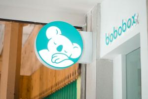 um sinal para uma porta de uma loja de cães negros em Bobopod Malioboro, Yogyakarta em Yogyakarta