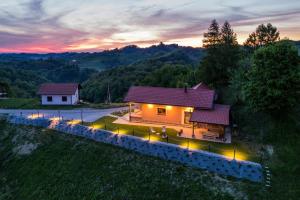 an aerial view of a house with lights in the yard at Hill Cottage Haloze in Gruškovec