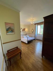 a room with a bedroom with a bed and a window at La Salmonière in Le Vivier-sur-Mer