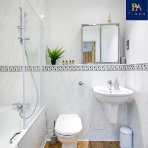 a bathroom with a toilet and a sink and a shower at Peaceful Serviced Apartment - Pluxa The Zen in Birmingham