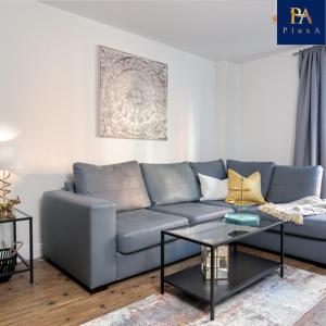 a living room with a blue couch and a table at Peaceful Serviced Apartment - Pluxa The Zen in Birmingham