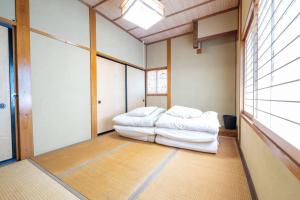 a living room with two white couches in a room at Green Hills in Itoigawa