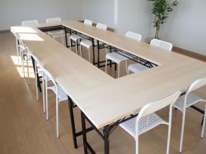una fila di tavoli e sedie in una stanza di Yadoya YADOKARI 2nd a Pippu