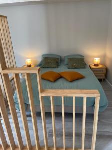 a bedroom with a bed with two candles on it at La Lit'Hote in Mirefleurs