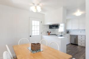 a kitchen with white cabinets and a table with a basket on it at Steps to the beach upstairs Apartment with 3 bedrooms & 2 bath AC in Kailua