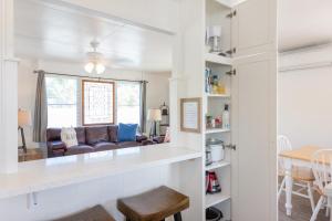 a kitchen and living room with a couch and a table at Steps to the beach upstairs Apartment with 3 bedrooms & 2 bath AC in Kailua
