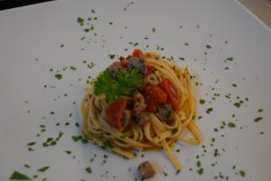 a plate of pasta with meat and vegetables at Hotel Albatros in Ischia