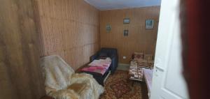 a room with a bed and a chair in a room at Стая за гости "Ирина" in Balchik