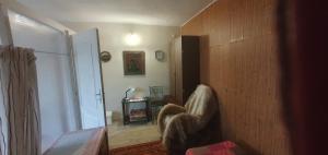 a room with a hallway with a chair and a door at Стая за гости "Ирина" in Balchik