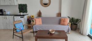 a living room with a couch and a table at Oasis Nature in Polis Chrysochous +9 photos