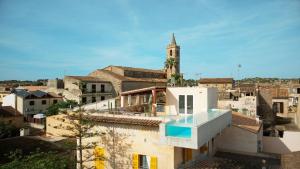 a view from the roof of a building with a swimming pool at Hotel Boutique Can Pocovi in Sant Llorenç des Cardassar