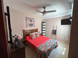 a bedroom with a bed and a ceiling fan at Casa Gloria in Los Abrigos