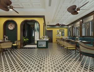 a restaurant with yellow walls and tables and chairs at Salute Premium Hotel & Spa in Hanoi