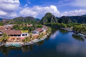 an aerial view of a resort on a river with boats at Tam Coc Phuong Nhi Homestay in Ninh Binh