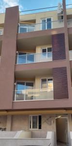 an apartment building with a balcony in front of it at Sandstone A8 Marsascala - 15minute drive to Valletta in Marsaskala