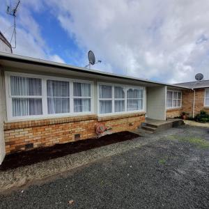 a brick house with windows and a satellite at Inner City 2 Bedroom Unit in Hamilton