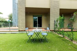 a patio with a table and chairs in a yard at Residence San Francesco in Tirrenia