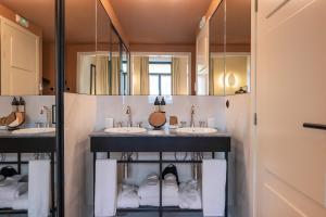 a bathroom with three sinks and two mirrors at Casa da Marechal - Boutique Hotel by Oporto Collection - Adults Only in Porto