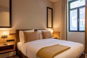 a bedroom with a large bed with a window at Casa da Marechal - Boutique Hotel by Oporto Collection - Adults Only in Porto