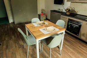 a kitchen with a wooden table and chairs in a kitchen at Residence San Francesco in Tirrenia