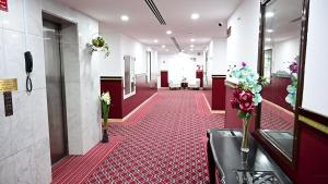 a corridor of a hospital with a red floor at Le Paradise Palace in Dubai