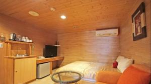 a bedroom with a bed in a room with wooden walls at 日月潭 -日月住館 in Yuchi