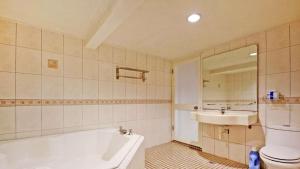 a bathroom with a tub and a toilet and a sink at 日月潭 -日月住館 in Yuchi +95 photos